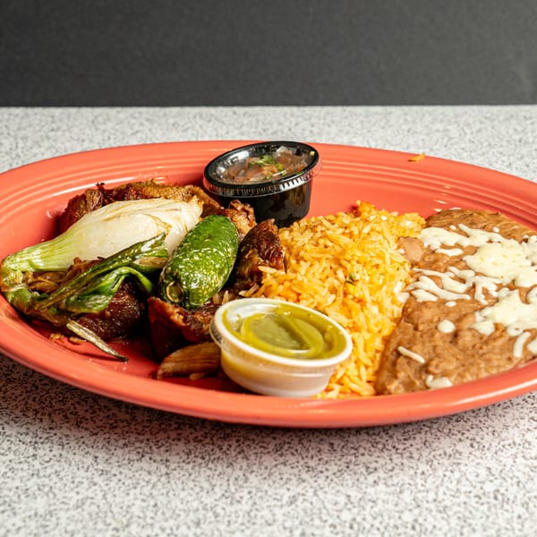 El Paso Mexican Restaurant's carne asada plate with rice, refried beans, grilled onions, and jalapeño.